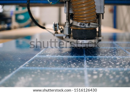 Milling cutter cuts plastic part on robotized production line. Factory robots used to produce precise an strict product on automation conveyor lines. Royalty-Free Stock Photo #1516126430