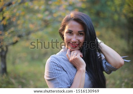 portrait of a girl with long black hair on an autumn walk