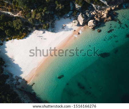 Aerial view of a tropical paradise beach with white sand and clear water in Nature Park Arrabida in Setubal, Portugal.