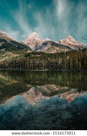 Amazing calm water reflections on Taggart Lake in Grand Teton National Park, Wyoming, USA in the summer.  Royalty-Free Stock Photo #1516173011