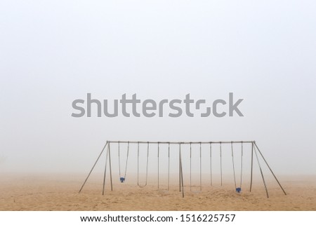 Swing in the beach in a heavy fog