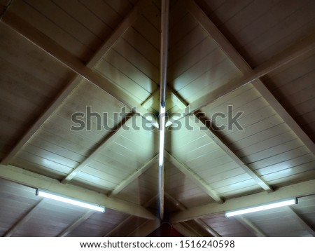 Fluorescent lamps installed on the wooden house ceiling