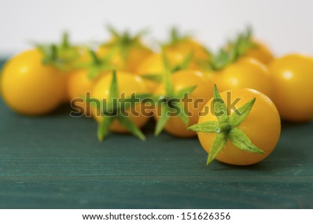 orange tomatoes, wooden table background
