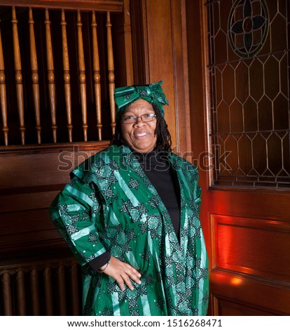 African American woman in a church with traditional green dress and head bandana