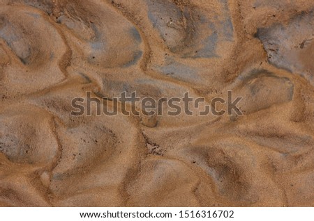 background abstract picture with undulating wet sandy silt in the former riverbed