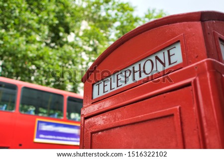 Telephone red booth with double decker bus in London.