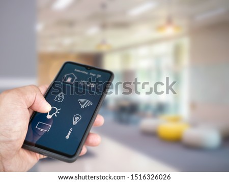 Smart home automation. hands holding smartphone to control the Electrical equipment in the house. Royalty-Free Stock Photo #1516326026