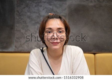 Closeup of young Asian woman sitting in the restaurant.