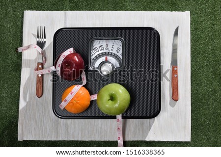 How to lose your weight. The image that composed by  all symbol such as fruits vegetable scale and tape Measure , set it all like a dish for losing weight. Royalty-Free Stock Photo #1516338365