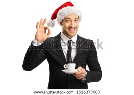 Businessman with a Christmas hat holding a cup of espresso coffee and gesturing perfect isolated on whote background