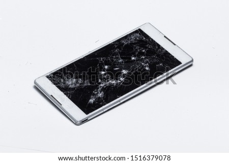 cracked screen on mobile device, white modern phone