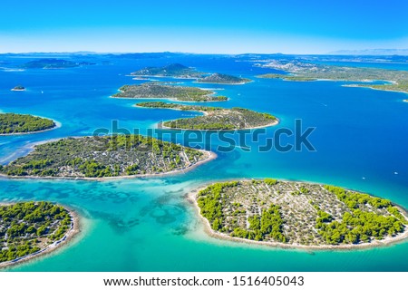 Beautiful blue coast in Croatia, small Mediterranean stone islands in Murter archipelago coastline, aerial view of turquoise bays from drone Royalty-Free Stock Photo #1516405043