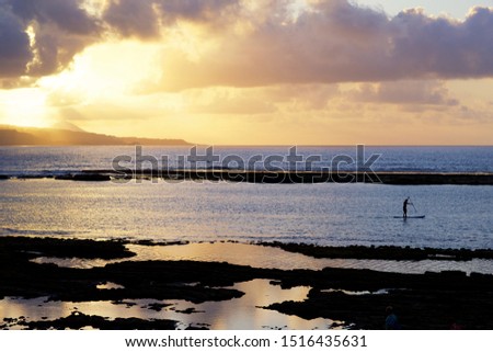 Silhouette of a man on a paddleboard at sunset. Beach of Las Canteras, Las Palmas de Gran Canaria, Spain. Royalty-Free Stock Photo #1516435631