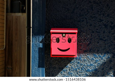 Red smiling mail box in Japan