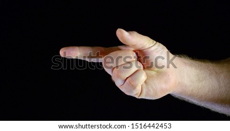 the man's hand is clenched into a fist. the man unbends one finger at a time. black background