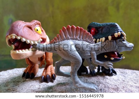 three toys dino playing together