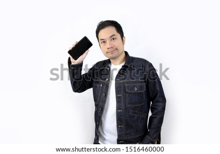 Asian men with smart phone Stand to take pictures my phone