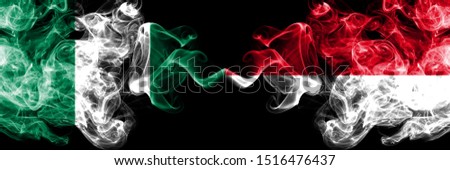 Nigeria vs Monaco, Monacan abstract smoky mystic flags placed side by side. Thick colored silky smoke flags of Nigerian and Monaco, Monacan