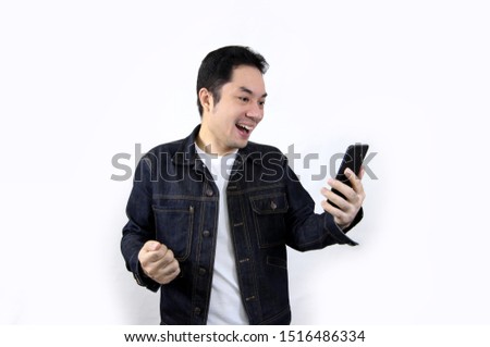 Asian men Happy with smart phone Stand to take pictures my phone