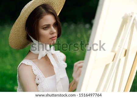 beautiful easel woman paints a picture