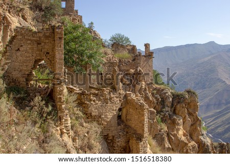 City - ghost, Dagestan, Russian - 1 SEPTEMBER, 2019: City of ancient ruins, city - ghost, mountainous area with green vegetation on background rocks, of blue sky and green forest