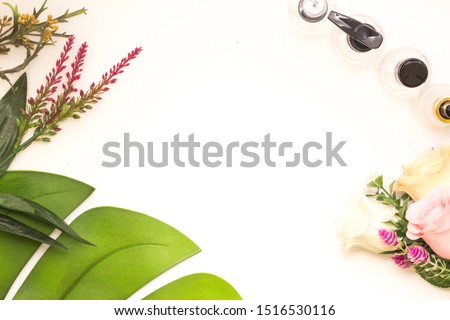 Simple cosmetic flat lay with make up bottle and nature on white background.
