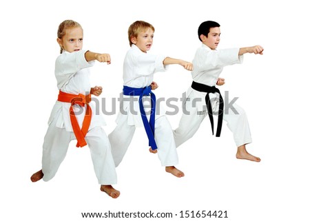 Three karateka in kimono hit a punch arm Royalty-Free Stock Photo #151654421
