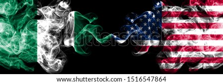 Nigeria vs United States of America, American abstract smoky mystic flags placed side by side. Thick colored silky smoke flags of Nigerian and United States of America, American