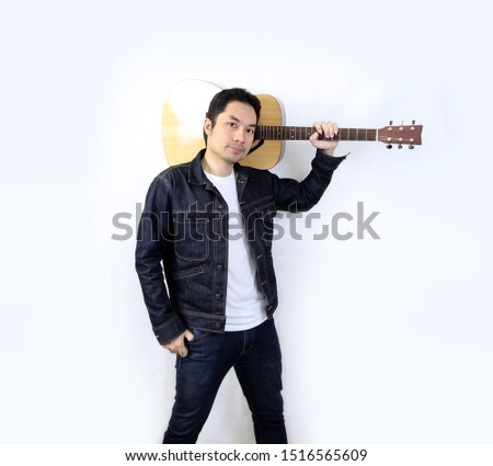 Asian men with guitar play music Stand to take pictures