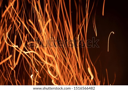 Beautiful golden lines of sparkles from fire flame with blurred light gold color on black background.