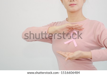 Pink shirt with a ribbon attached to the chest.Do not focus on objects.World Breast Cancer Day Concept.