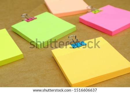 Notepad with set of colorful paper clips on white background.business creativity concepts Colored pencils.Flat lay design
