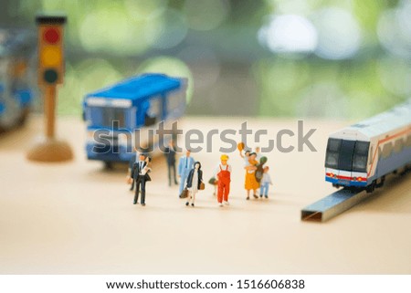 Miniature people: Traffic within the capital between people and public bus or train. Image use for business concept.