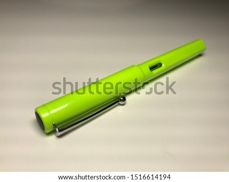 Macro shot of green ballpoint pen made of different alternative compositions on white background, make drawing conceptual pen shoot stationery products object write.