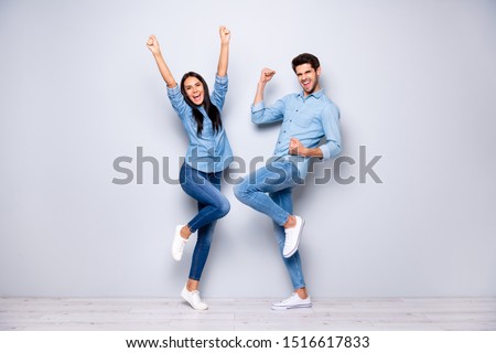 Full size photo of guy and lady celebrating successful business project raising fists air wear casual jeans clothes isolated grey color background