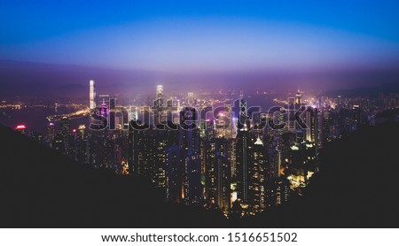 (Filtered picture) View from above, stunning view of the illuminated Hong Kong skyline during a beautiful sunset. Picture taken from the Victoria Peak. 