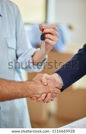 Handshake close-up. Make deal. Men shake hands. Woman holds keys.