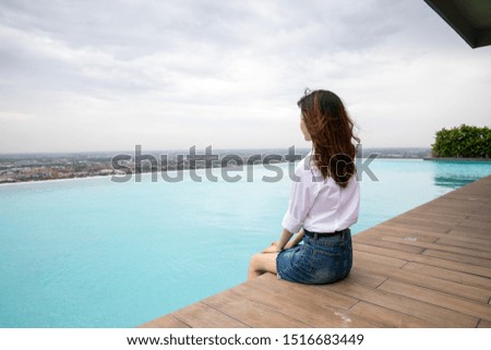 A girl sitting by the pool