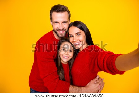 Photo of cheerful funky cute adorable people together family boyfriend hugging daughter girlfriend wearing red sweaters taking selfie toothily isolated over vivid color yellow background