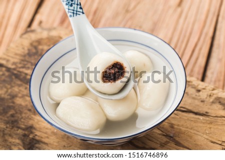 Tang Yuan(sweet dumplings) made from glutinous filled with black sesame in ginger syrup. Traditional cuisine for lantern festival, Mid-autumn festival, Dongzhi (winter solstice) and Chinese new year.
 Royalty-Free Stock Photo #1516746896