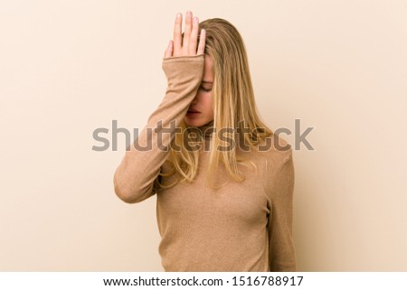 Cute and natural teenager woman forgetting something, slapping forehead with palm and closing eyes.