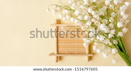 Mockup. Lilies of the valley on a light background. Bouquet of spring flowers. Selective focus.