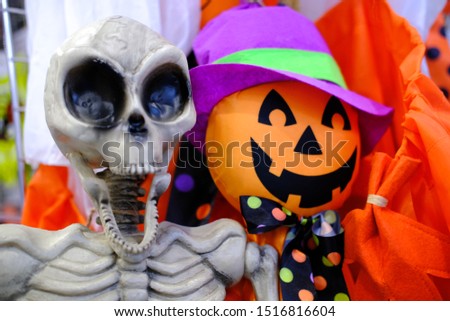Jack O Lanterns pumpkin and skeleton dolls with smiling face. Happy halloween. Orange colors. - holidays, decoration and party concept