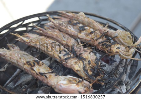 Close up of crunchy uncooked organic seasoned on a hot charcoal barbecue 