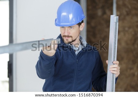 a male builder is installing the metal frames