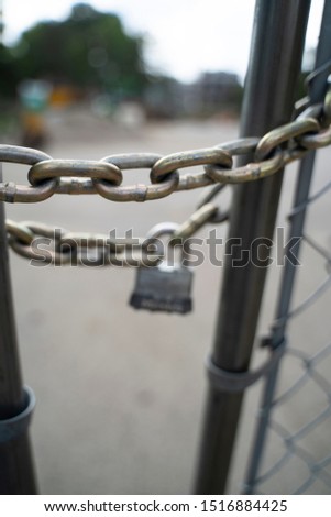 Lock and Chain on Wire Fence Entrance