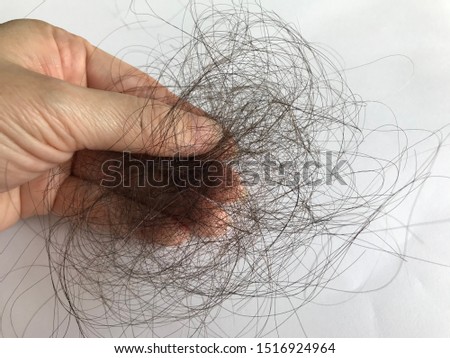 A handful of hair, problem from hair loss Royalty-Free Stock Photo #1516924964