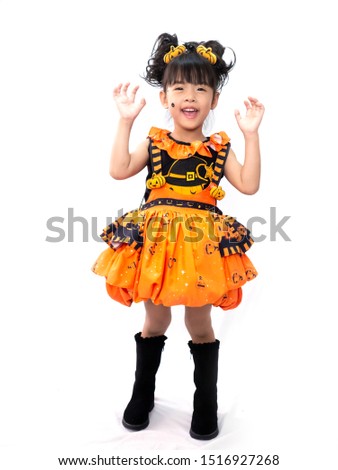 Asian children girl in pumpkin dress costume for Halloween decoration in white background