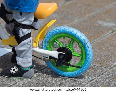 A pedalless bicycle for infants. Kick the ground with your feet and proceed.