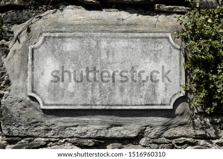 stone panel isolated in a park space for text, cracked wall with panel
